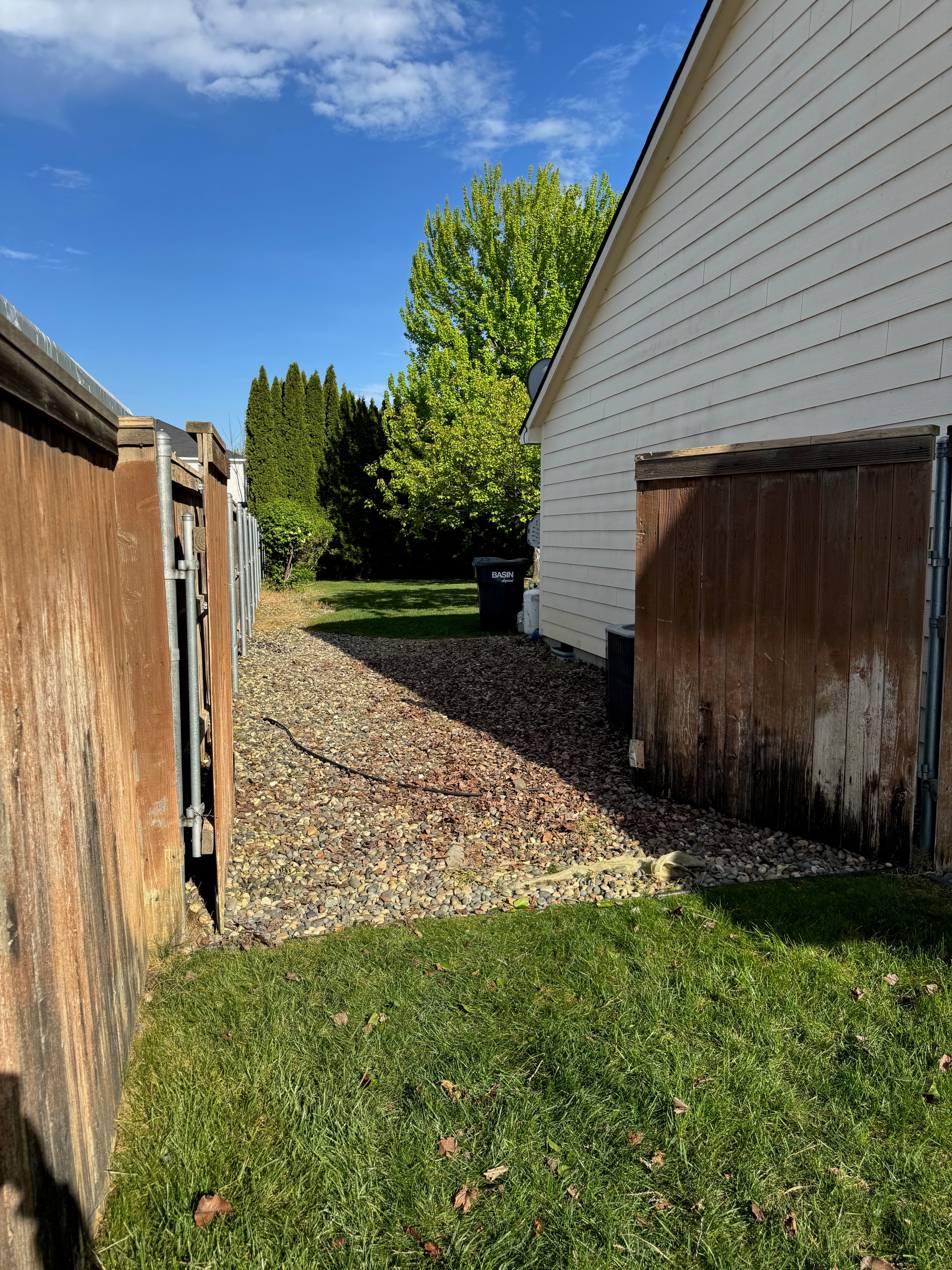 Clean side yard entrance through gate after outdoor junk removal